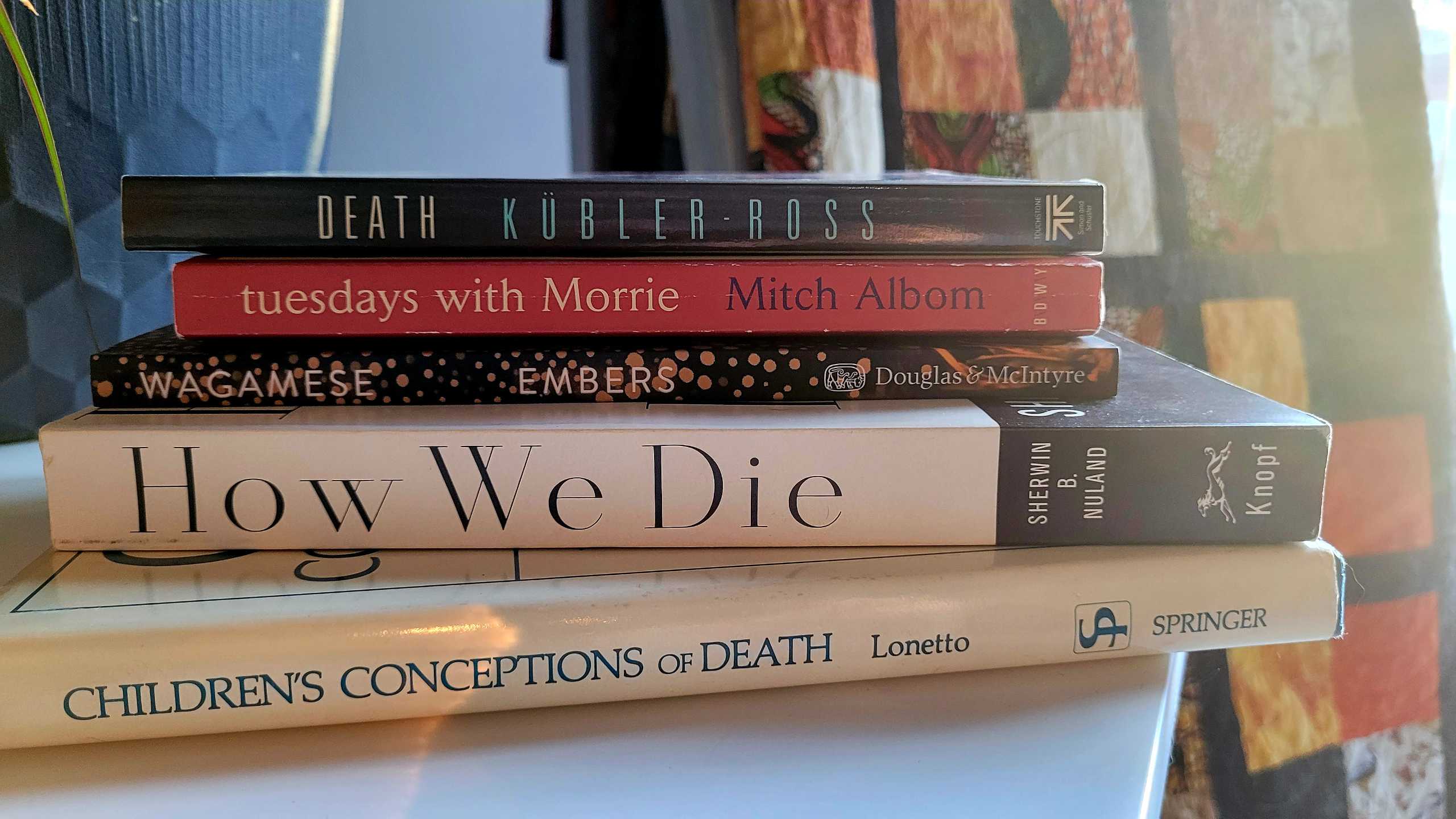 A stack of books related to death and dying