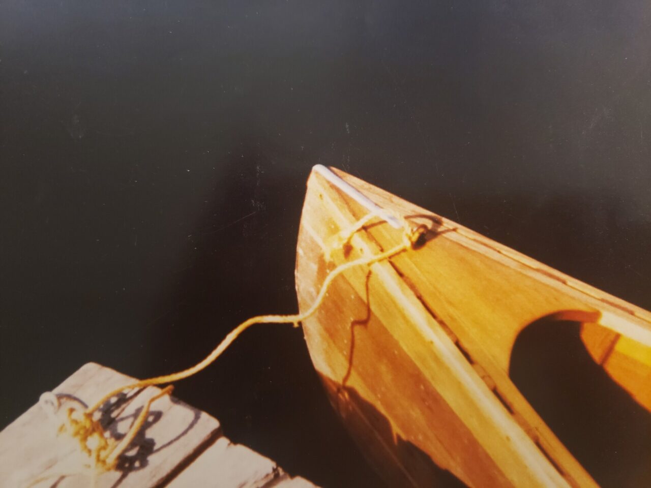 Bow of a Canoe On A Dark Lake