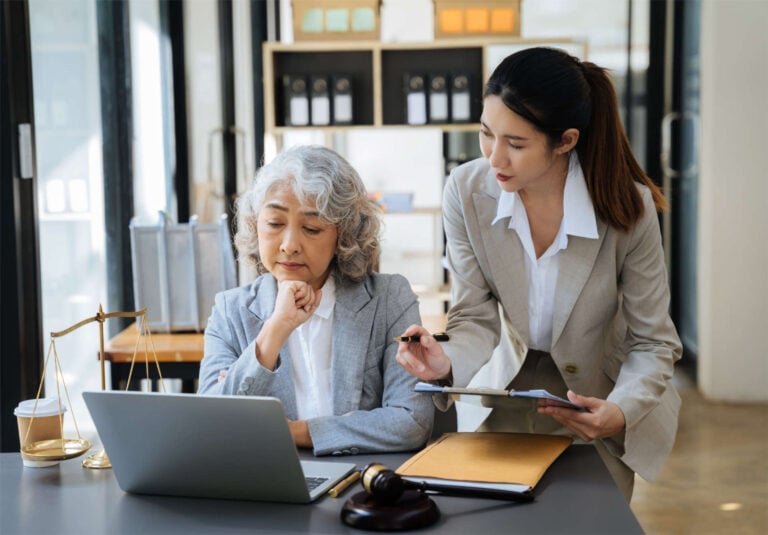 An elderly woman reviewing her online accounts