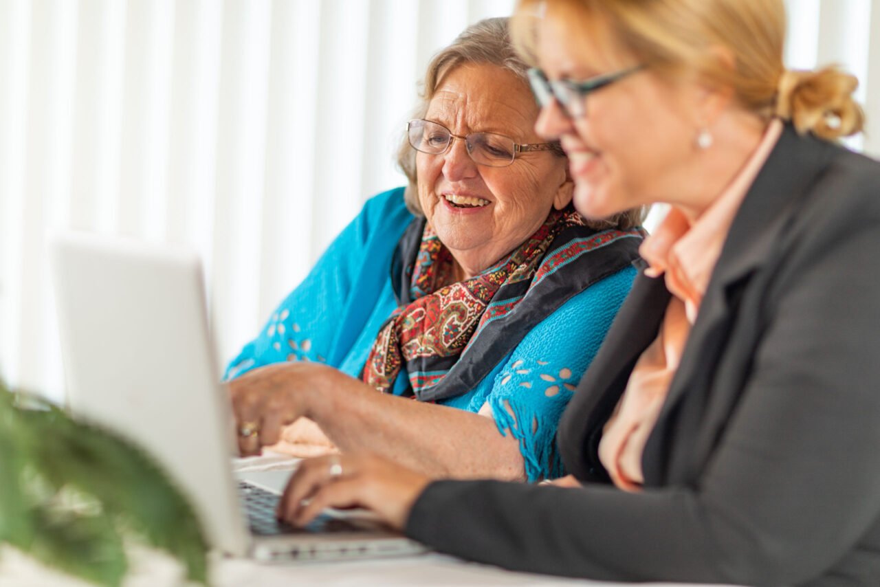 Woman Helping Senior Secure Her Accounts